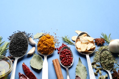 Photo of Different aromatic spices on blue background. Space for text
