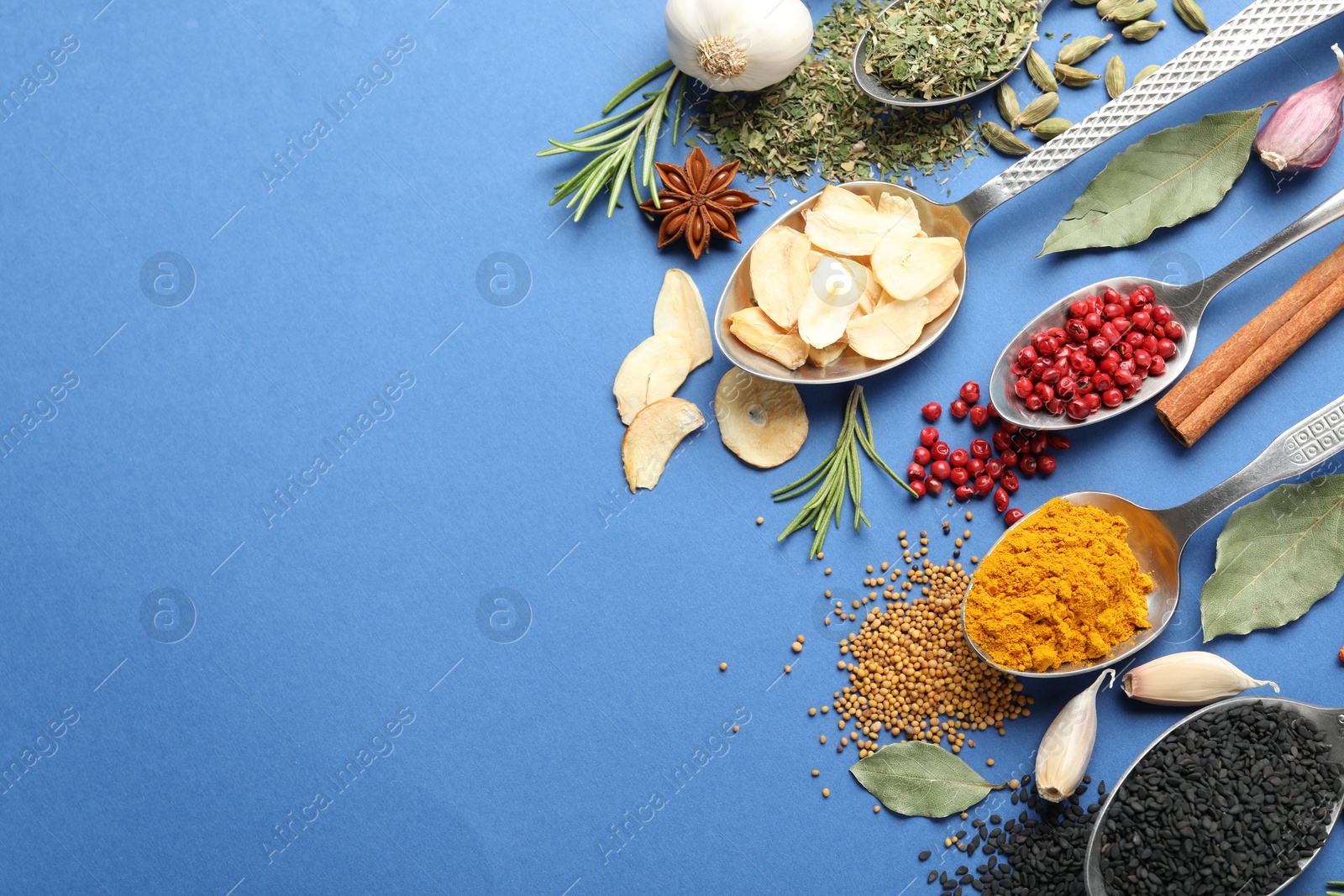 Different aromatic spices on blue background, flat lay. Space for text Photo of Different aromatic spices on blue background, flat lay. Space for text
