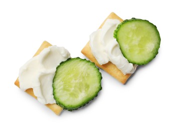 Photo of Tasty crackers with cream cheese and cucumber isolated on white, top view