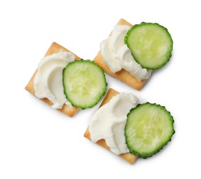 Photo of Tasty crackers with cream cheese and cucumber isolated on white, top view