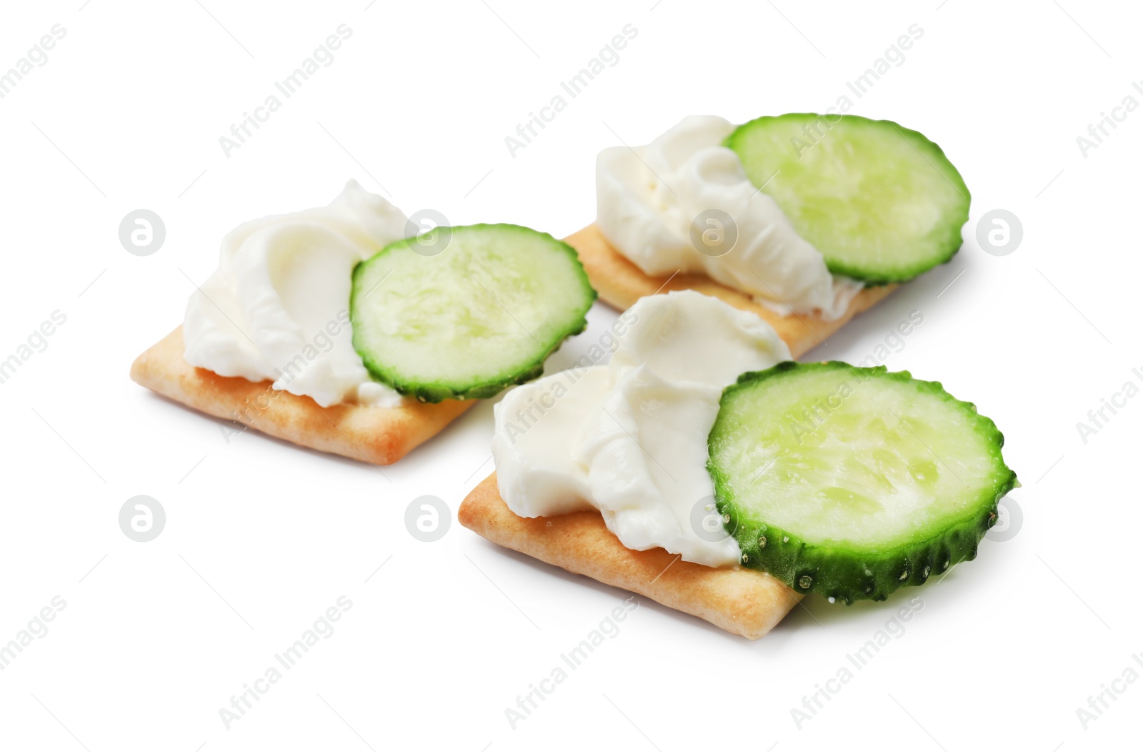 Tasty crackers with cream cheese and cucumber isolated on white Photo of Tasty crackers with cream cheese and cucumber isolated on white