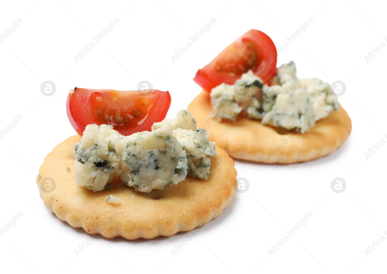 Tasty crackers with blue cheese and tomatoes isolated on white Photo of Tasty crackers with blue cheese and tomatoes isolated on white