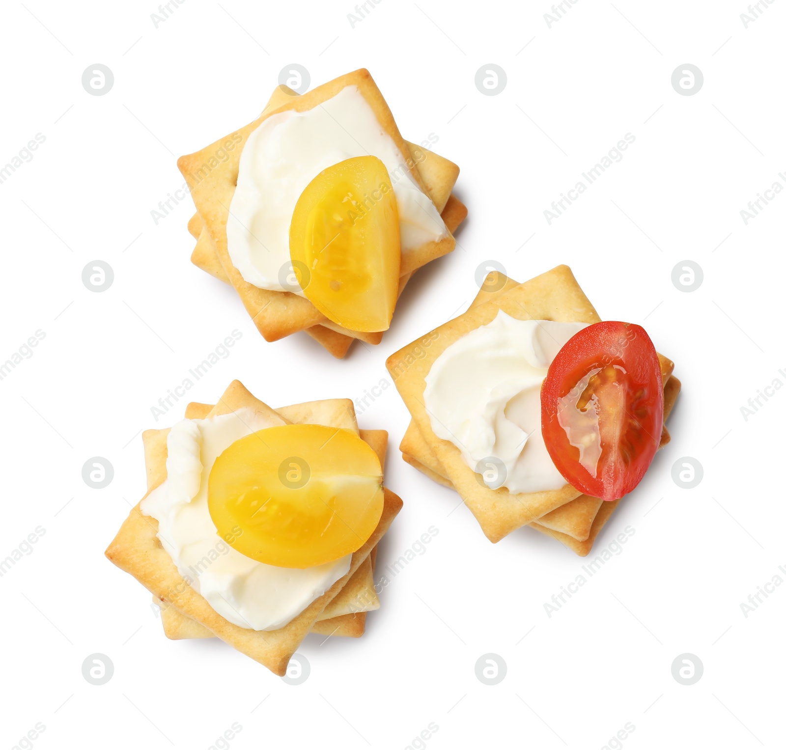 Tasty crackers with cream cheese and tomatoes isolated on white, top view Photo of Tasty crackers with cream cheese and tomatoes isolated on white, top view
