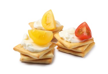 Photo of Tasty crackers with cream cheese and tomatoes isolated on white