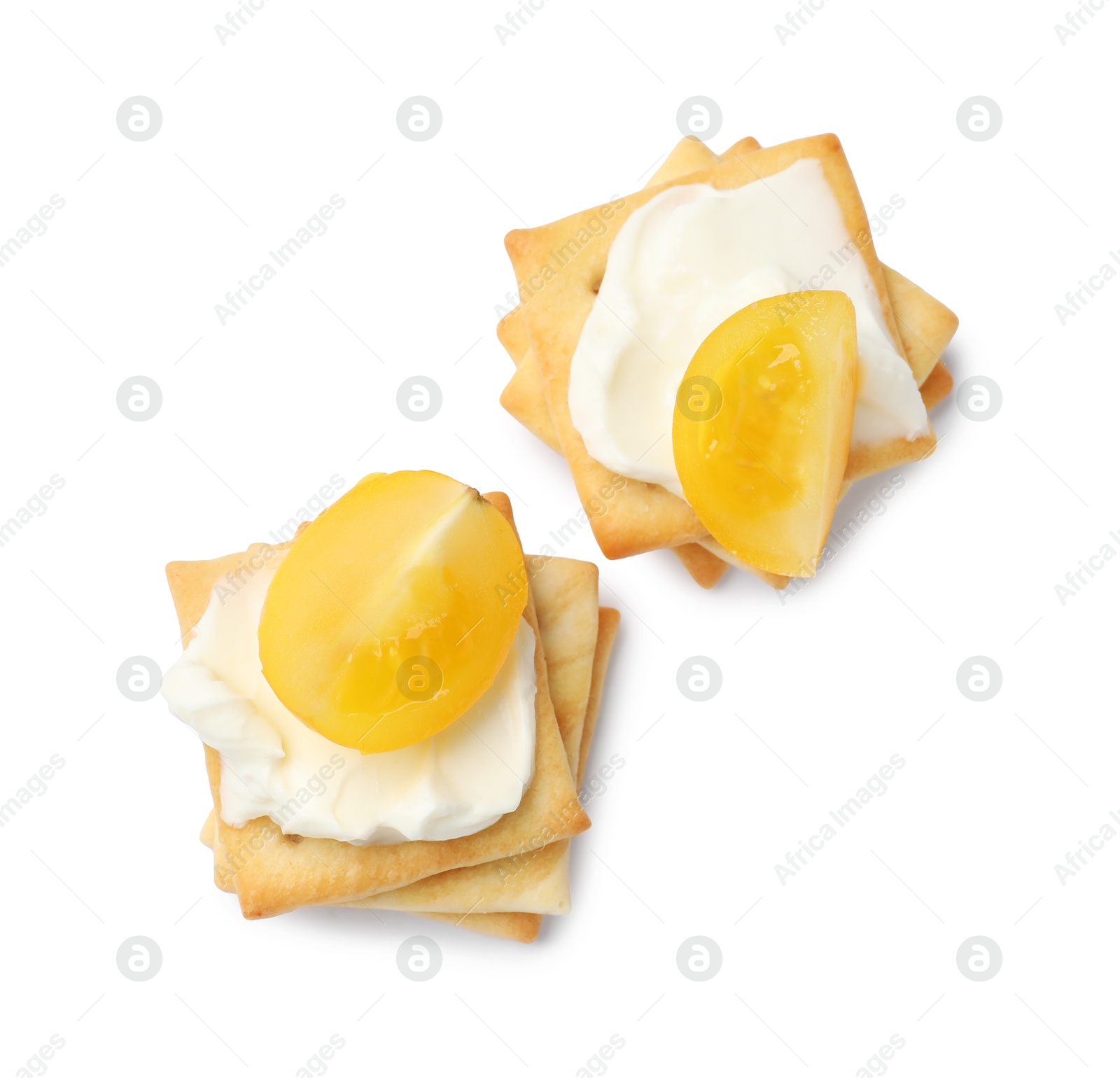 Tasty crackers with cream cheese and tomatoes isolated on white, top view Photo of Tasty crackers with cream cheese and tomatoes isolated on white, top view