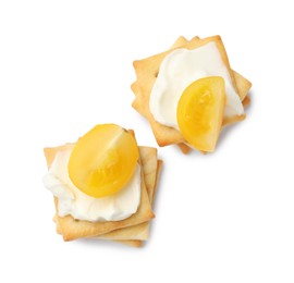 Photo of Tasty crackers with cream cheese and tomatoes isolated on white, top view