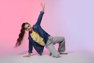 Photo of Girl in stylish clothes dancing on color background, space for text