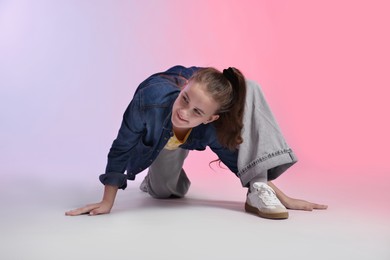 Photo of Girl in stylish clothes dancing on color background