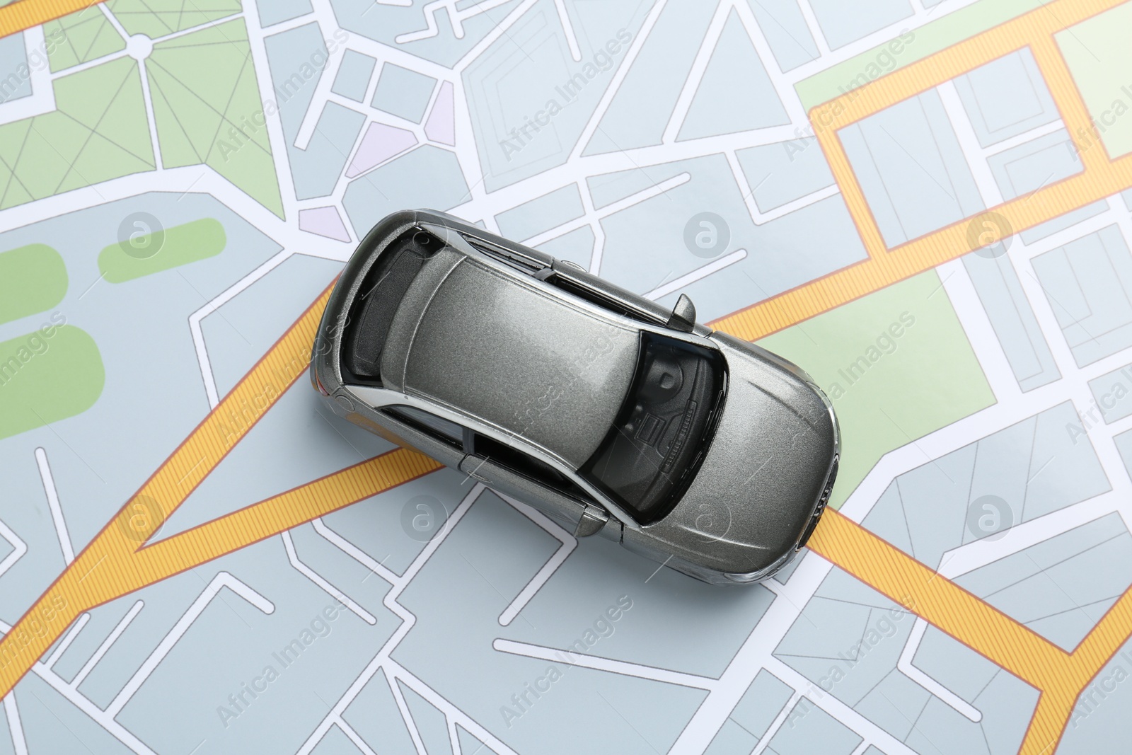 Road trip concept. Car model on city map, top view Photo of Road trip concept. Car model on city map, top view