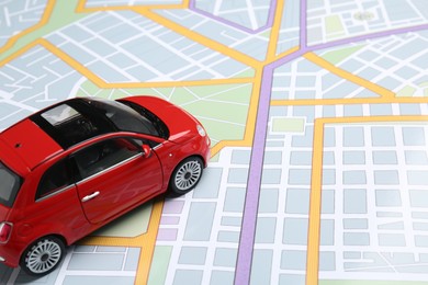 Photo of Road trip concept. Car model on city map, closeup
