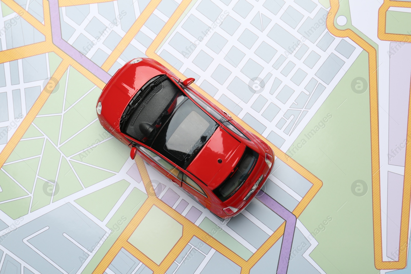 Road trip concept. Car model on city map, top view Photo of Road trip concept. Car model on city map, top view