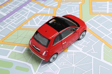 Photo of Road trip concept. Car model on city map, closeup