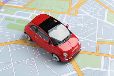 Photo of Road trip concept. Car model on city map, closeup