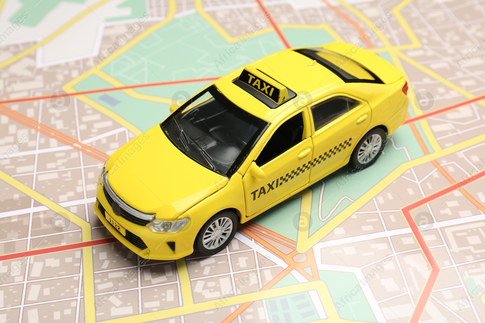 Road trip concept. Car model on city map, closeup Photo of Road trip concept. Car model on city map, closeup