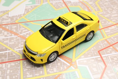 Photo of Road trip concept. Car model on city map, closeup