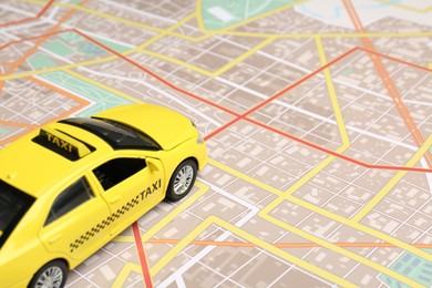 Photo of Road trip concept. Car model on city map, closeup
