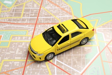Photo of Road trip concept. Car model on city map, closeup