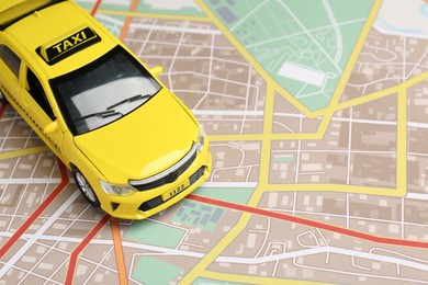 Photo of Road trip concept. Car model on city map, closeup