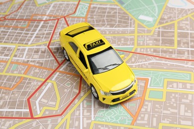Photo of Road trip concept. Car model on city map, closeup