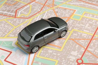 Photo of Road trip concept. Car model on city map, closeup