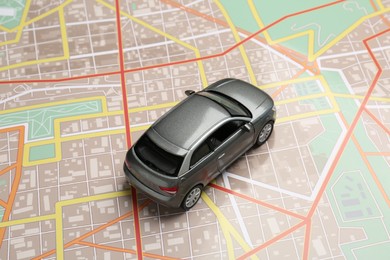 Photo of Road trip concept. Car model on city map