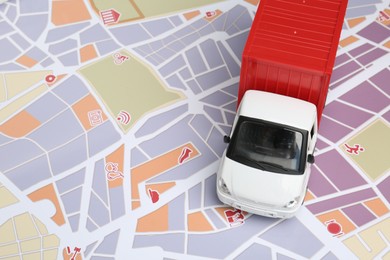 Photo of Truck model on city map. Delivery concept