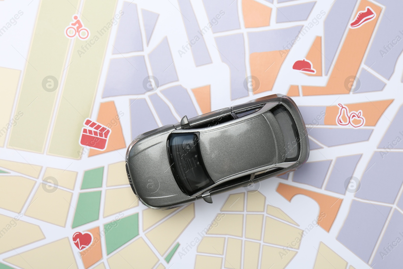 Road trip concept. Car model on city map, top view Photo of Road trip concept. Car model on city map, top view