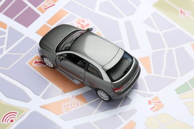 Photo of Road trip concept. Car model on city map