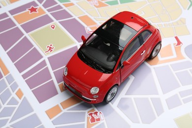 Photo of Road trip concept. Car model on city map