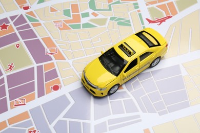 Photo of Road trip concept. Car model on city map