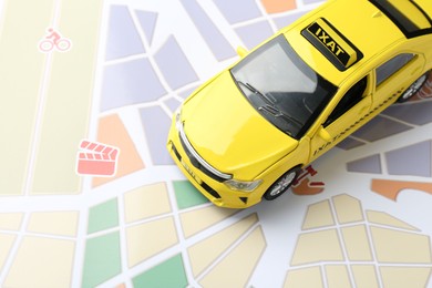 Photo of Road trip concept. Car model on city map