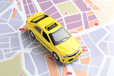 Photo of Road trip concept. Car model on city map