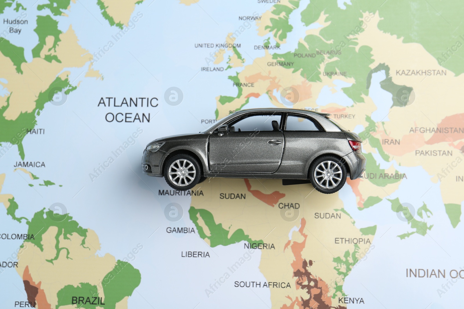 Road trip concept. Car model on world map, top view Photo of Road trip concept. Car model on world map, top view