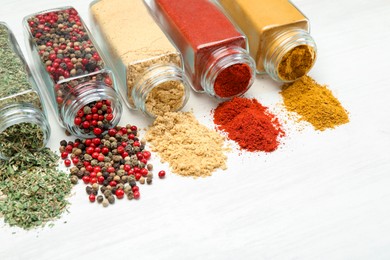 Photo of Different aromatic spices in jars on white table