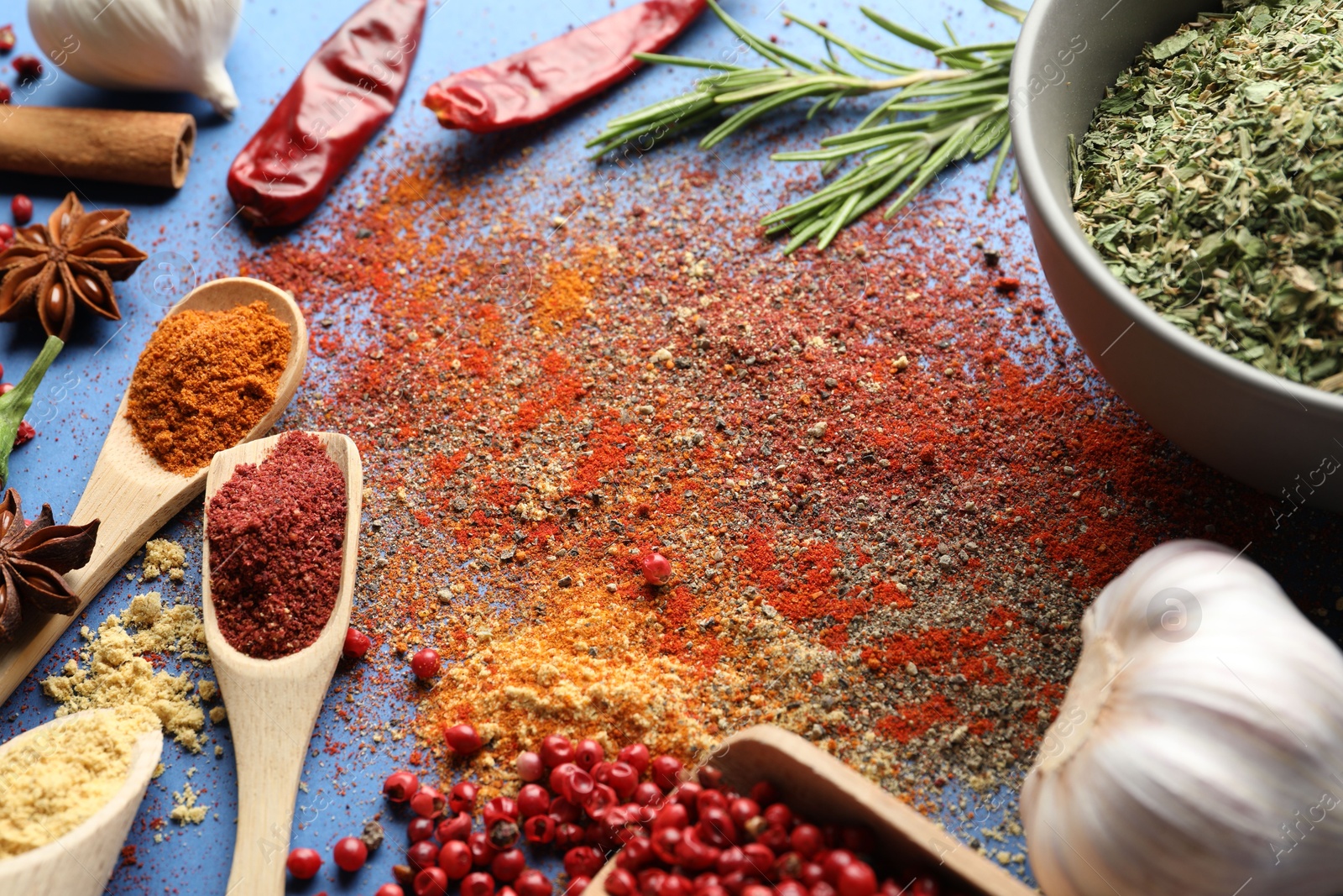 Different aromatic spices on blue background, closeup Photo of Different aromatic spices on blue background, closeup