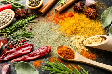 Photo of Different aromatic spices on black background, closeup