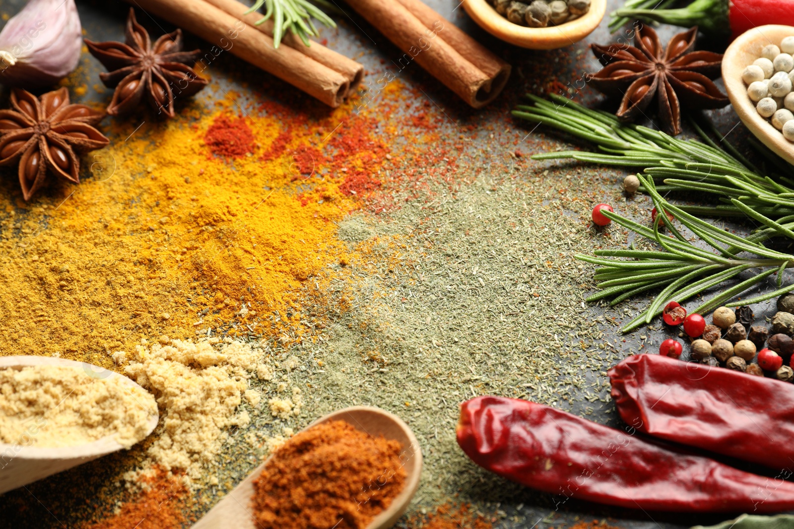 Different aromatic spices on black background, closeup Photo of Different aromatic spices on black background, closeup
