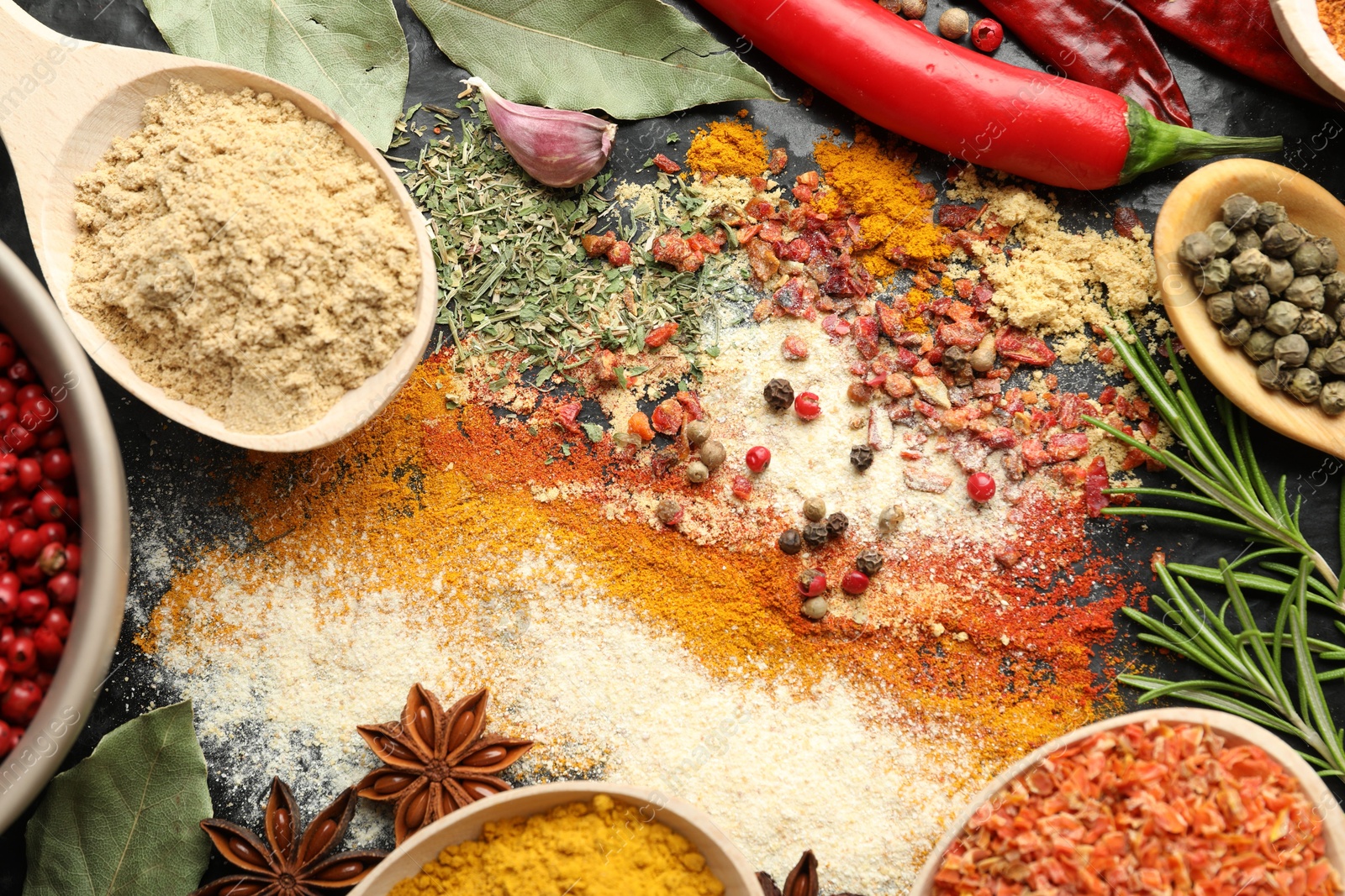 Different aromatic spices on black background, closeup Photo of Different aromatic spices on black background, closeup