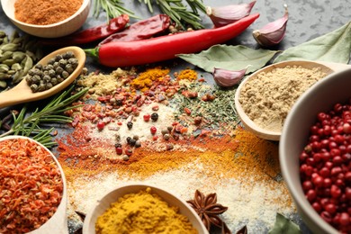 Photo of Different aromatic spices on black background, closeup