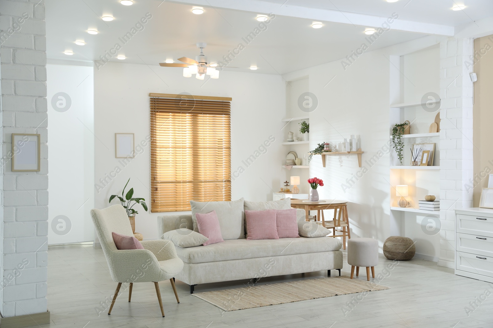 Comfortable sofa with cushions in room. Interior design Photo of Comfortable sofa with cushions in room. Interior design