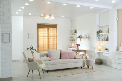 Photo of Comfortable sofa with cushions in room. Interior design