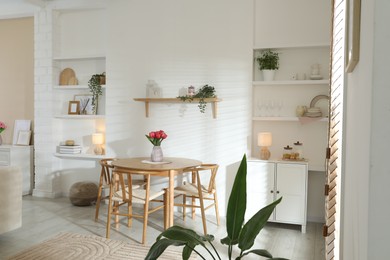Photo of Stylish dining table with chairs in room. Interior design