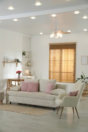 Photo of Comfortable sofa with cushions in room. Interior design