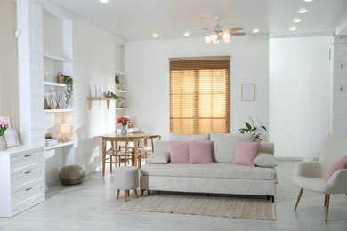 Photo of Comfortable sofa with cushions in room. Interior design