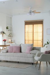 Photo of Comfortable sofa with cushions in room. Interior design