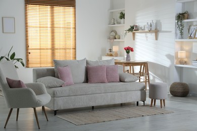 Photo of Comfortable sofa with cushions in room. Interior design