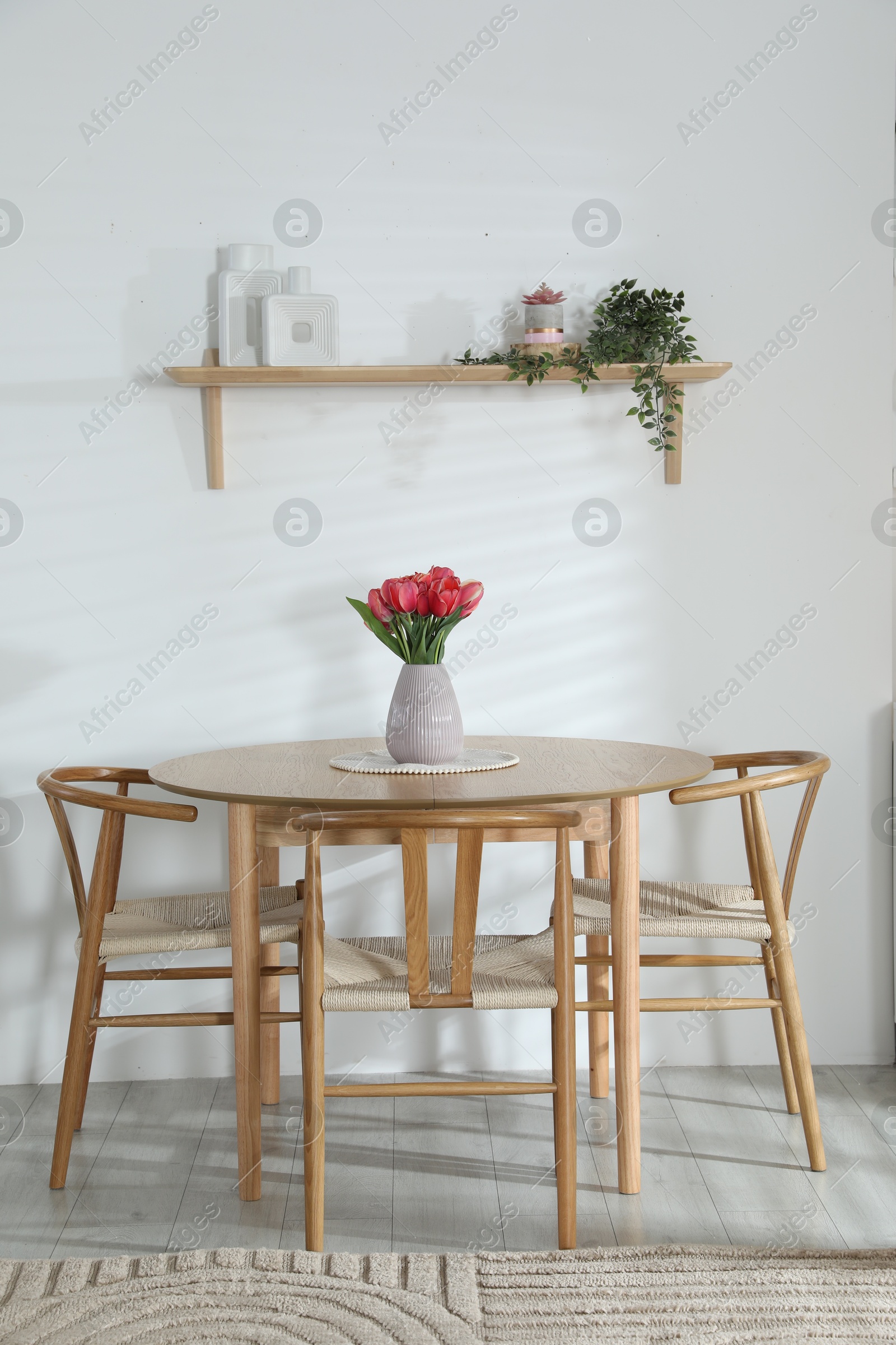 Stylish dining table with chairs in room. Interior design Photo of Stylish dining table with chairs in room. Interior design