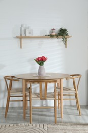 Photo of Stylish dining table with chairs in room. Interior design