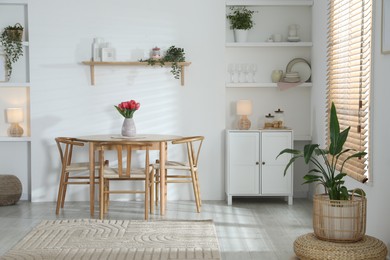 Photo of Stylish dining table with chairs in room. Interior design