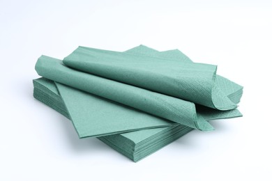 Photo of Many green paper handkerchiefs isolated on white
